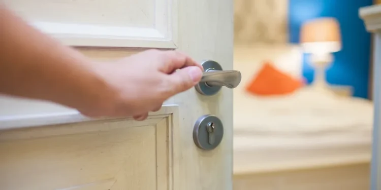 Person opens the door | Source: Shutterstock