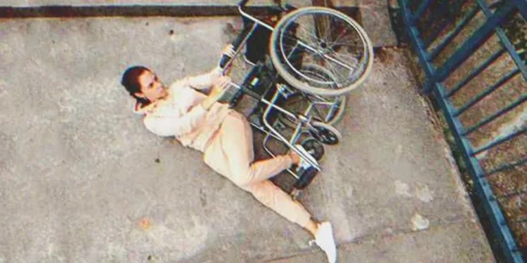 Disabled woman falling off a wheelchair | Source: Shutterstock