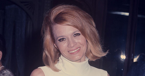 Angie Dickinson at a formal event wearing a white bare midriff dress; circa 1970; New York. (Photo by Art Zelin/Getty Images)
