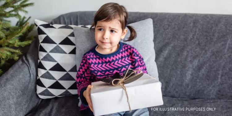 A young girl with a present | Source: Shutterstock